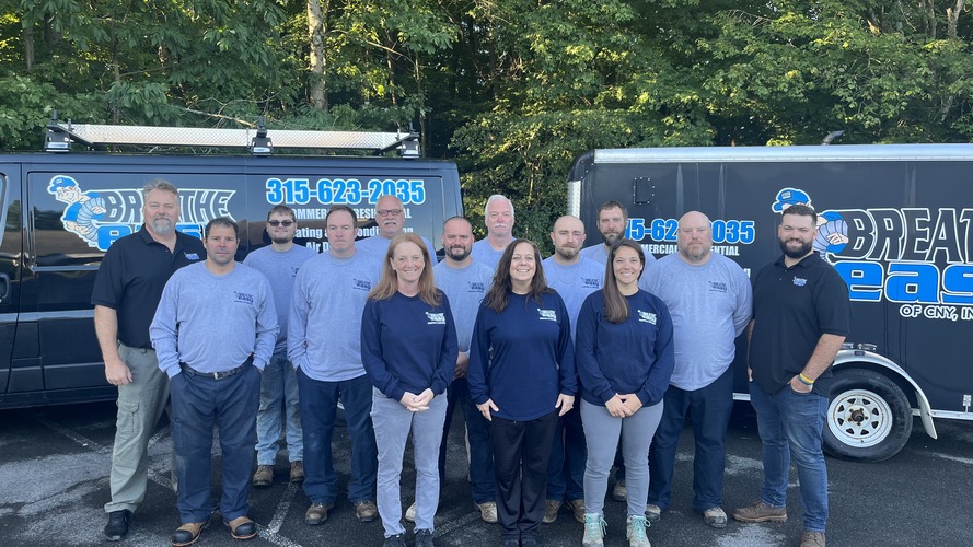 Our team standing in front our service trucks